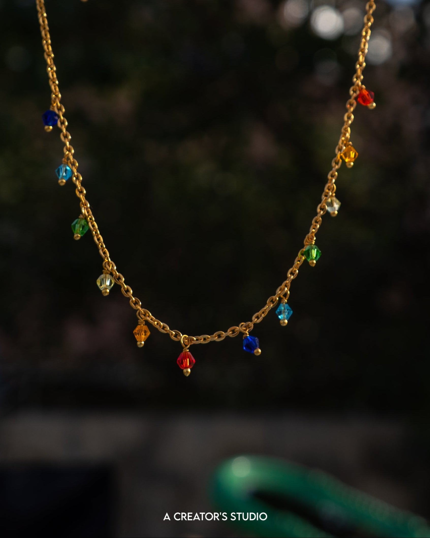 Gold plated necklace with rainbow coloured beads handmade by A Creator's Studio