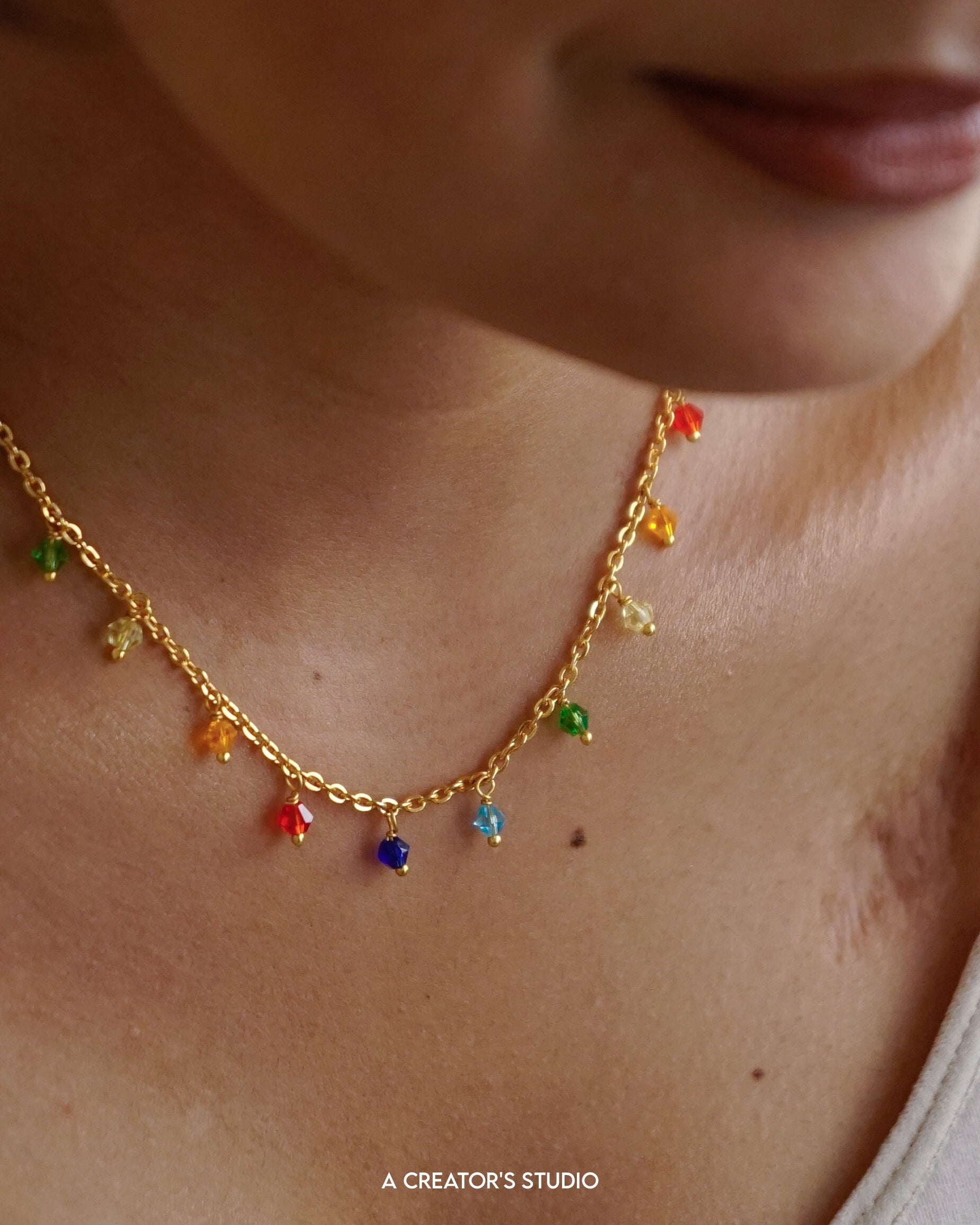 Gold Plated necklace with rainbow coloured glass beads handmade by A Creator's Studio