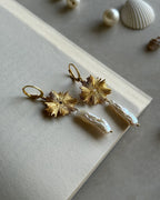 Gold plated dangle earrings with a flower charm and a freshwater pearl drop handmade by A Creator's Studio