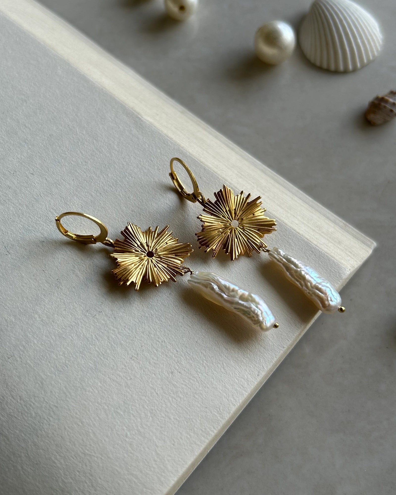 Gold plated dangle earrings with a flower charm and a freshwater pearl drop handmade by A Creator's Studio