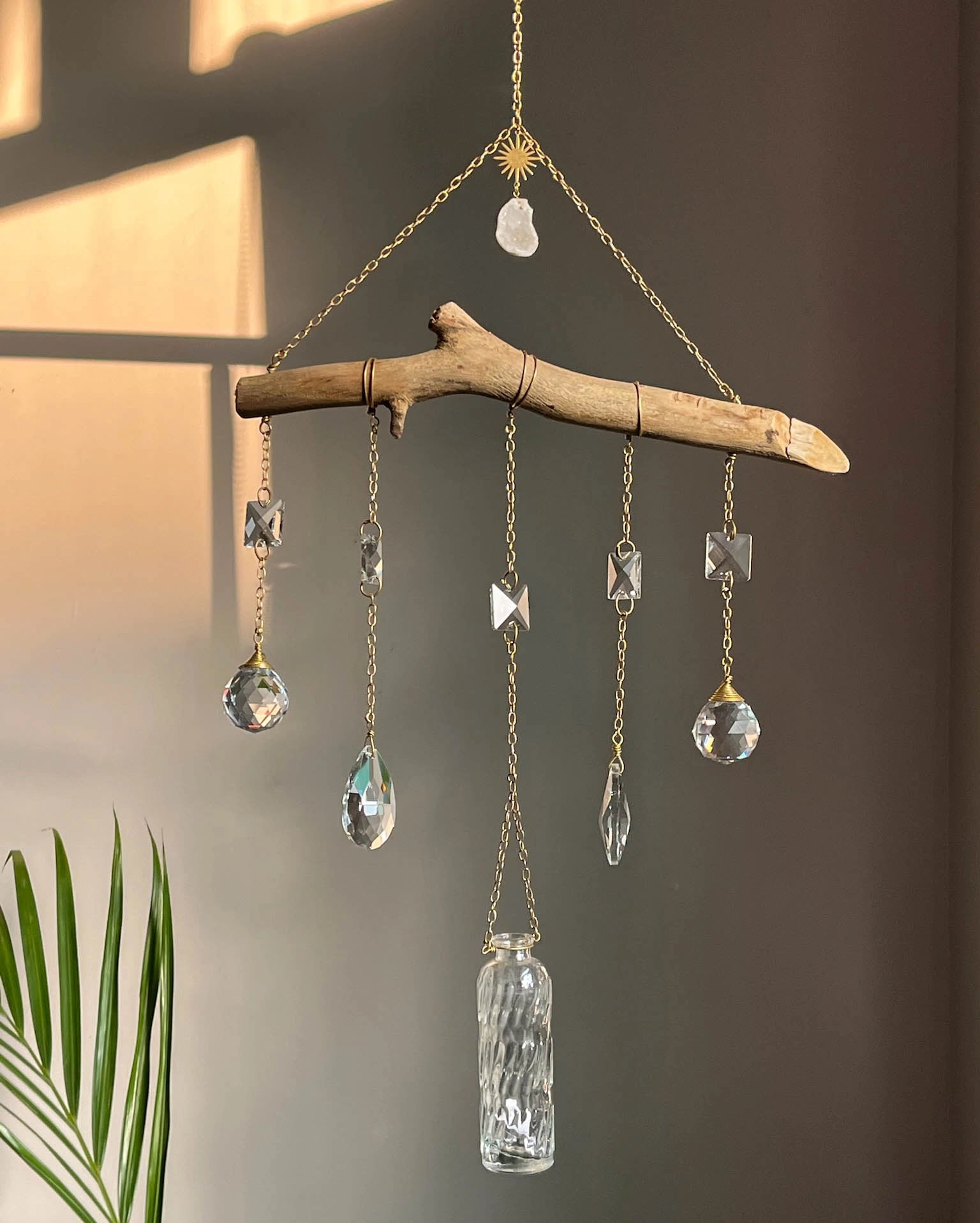 upcycled sun catcher with glass crystals, a wooden log base and a geode handmade by A Creator's Studio