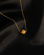 Brass necklace with orange Carnelian crystal bead in the centre handmade by A Creator's Studio