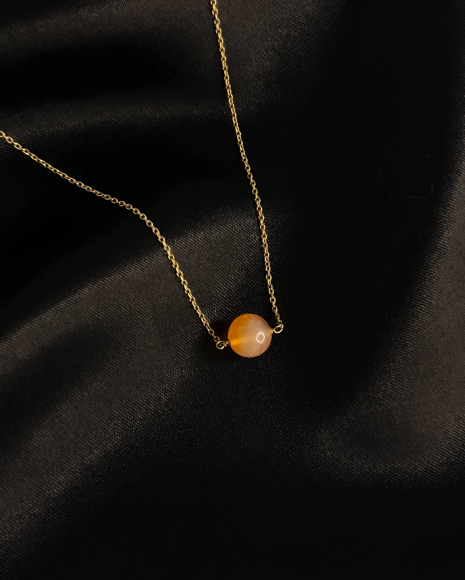 Brass necklace with orange Carnelian crystal bead in the centre handmade by A Creator's Studio