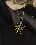 Brass wired sun necklace with a crystal in the centre handmade by A Creator's Studio