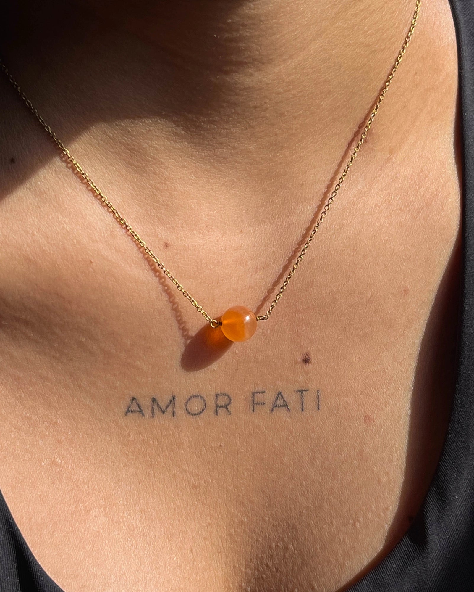 Brass necklace with orange Carnelian crystal bead in the centre handmade by A Creator's Studio