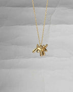 Brass necklace with a balloon dog pendant handmade by A Creator's Studio