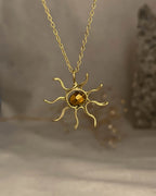Brass wired sun necklace with a crystal in the centre handmade by A Creator's Studio