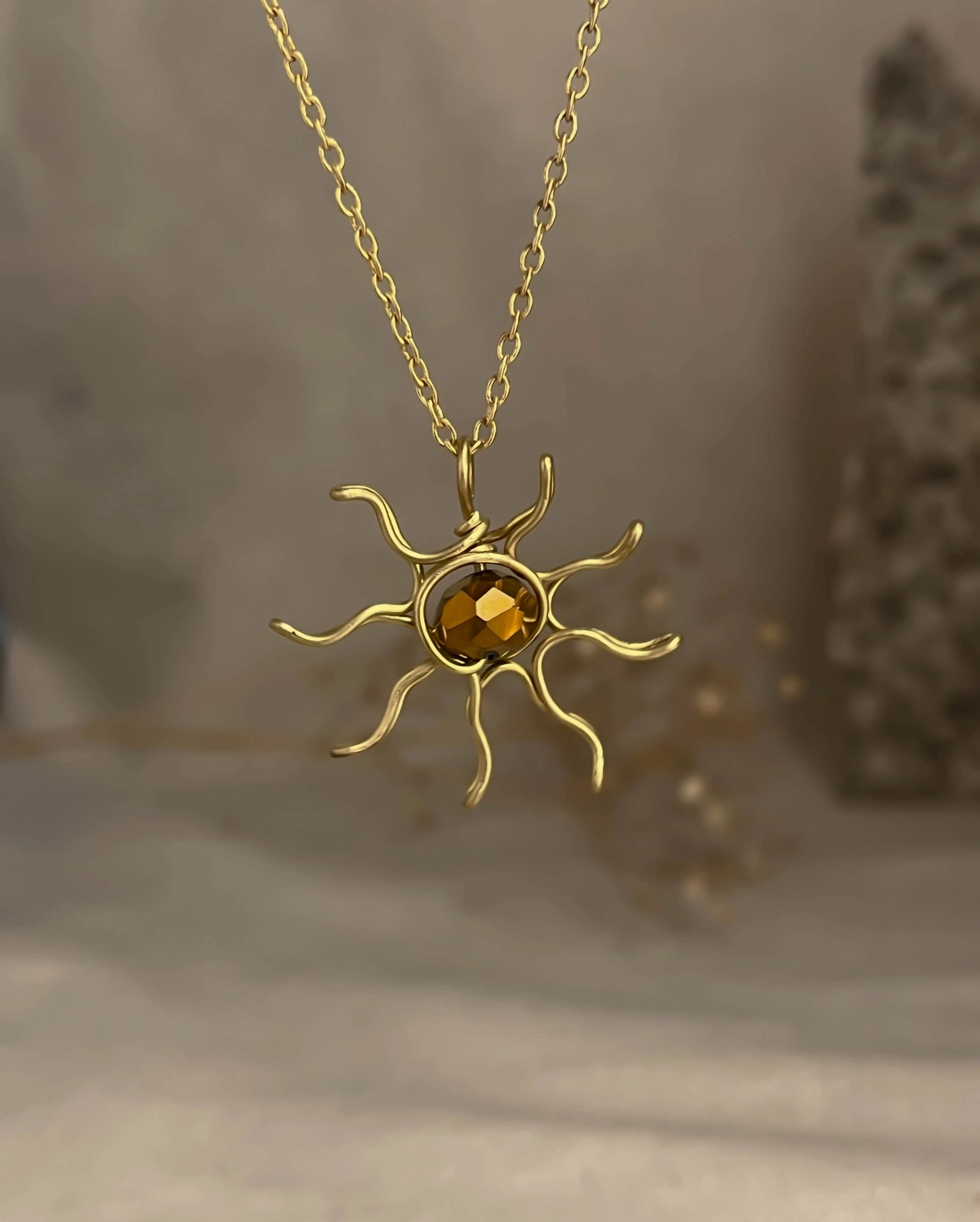 Brass wired sun necklace with a crystal in the centre handmade by A Creator's Studio