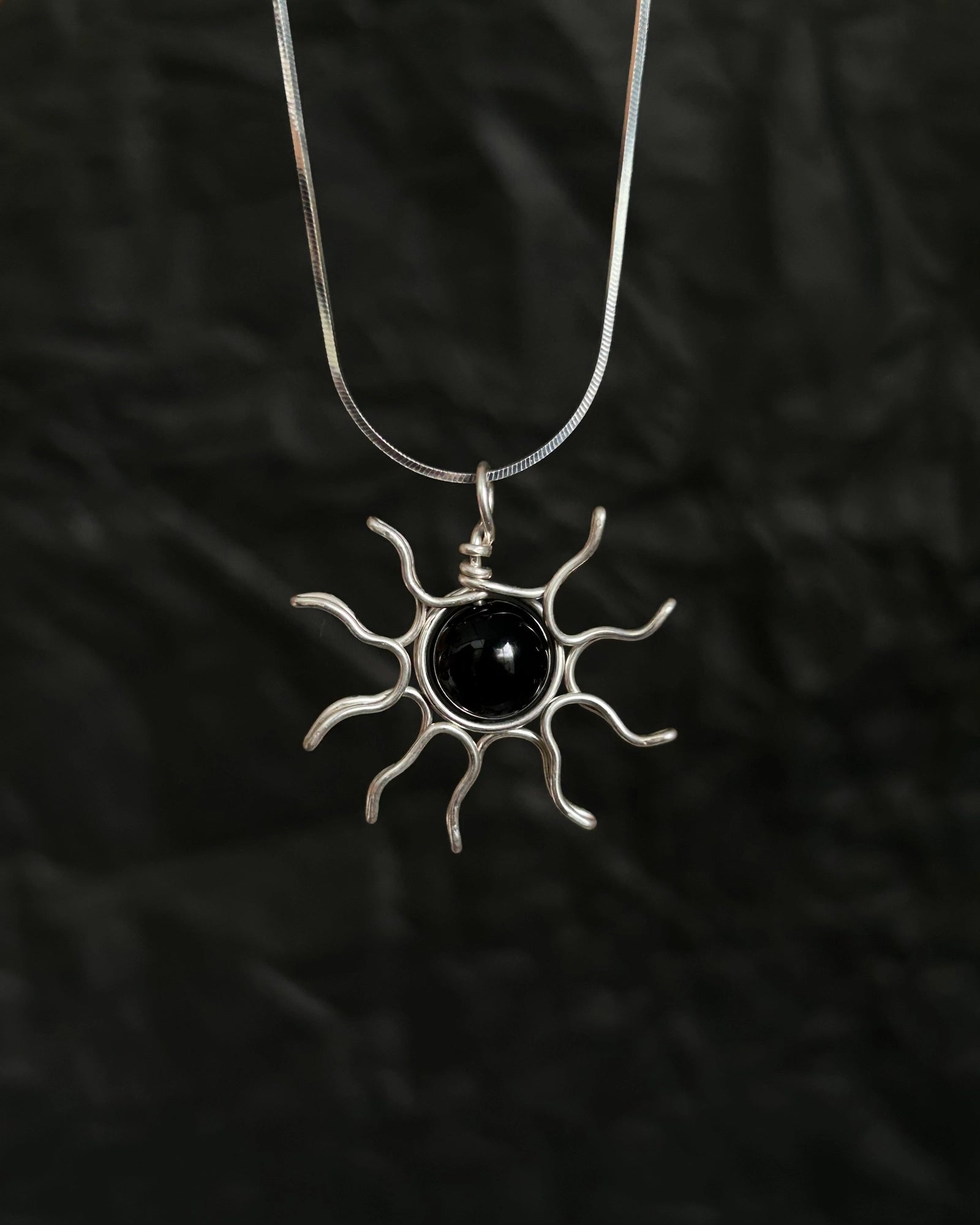 Sterling Silver Necklace with a wire wrapped sun pendant with a black onyx gemstone handmade by A Creator's Studio