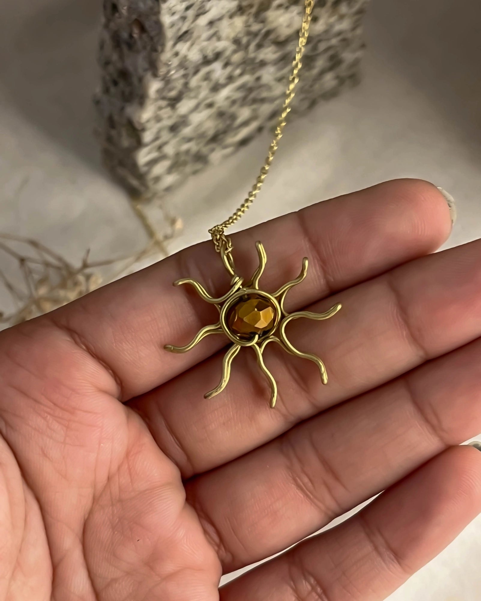 Brass wired sun necklace with a crystal in the centre handmade by A Creator's Studio