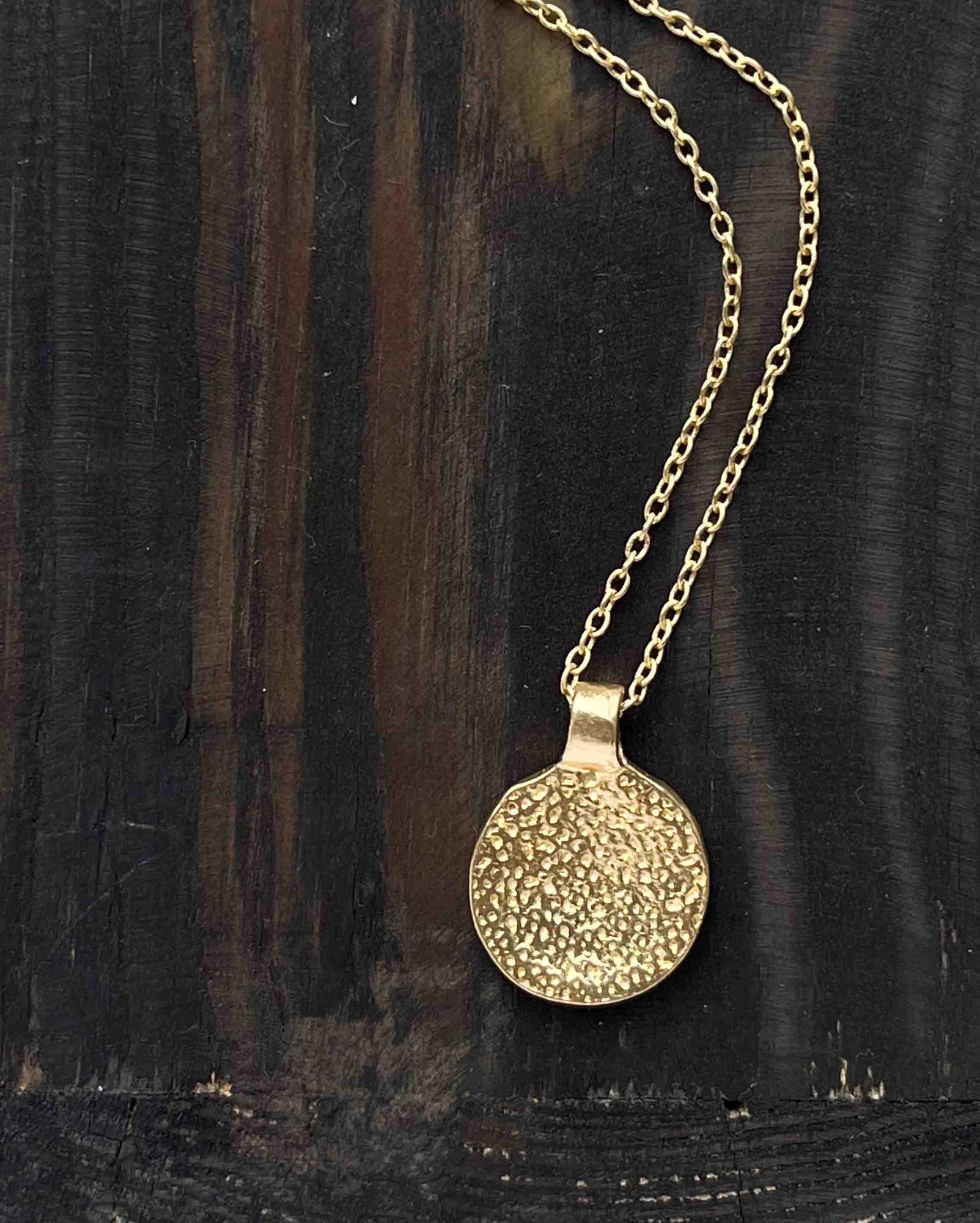 Brass necklace with a hammer texture coin pendant handmade by A Creator's Studio