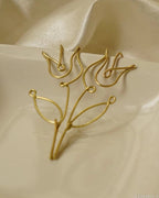 Rose shaped brass earrings handmade by a creator's studio