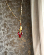 Brass necklace with a hand pendant and red crystal drops handmade by A Creator's Studio