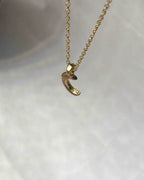 Brass necklace with a crescent moon pendant handmade by A Creator's Studio