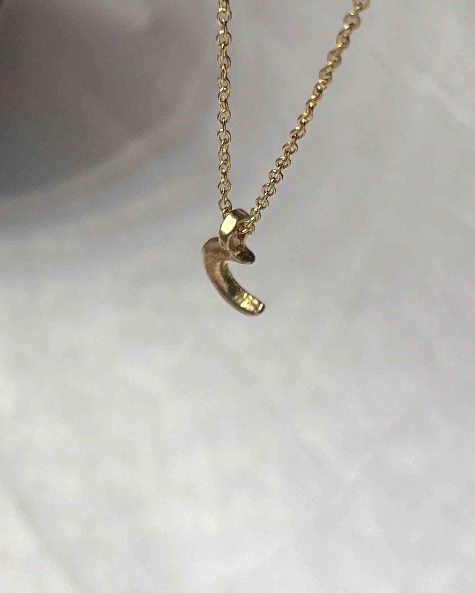 Brass necklace with a crescent moon pendant handmade by A Creator's Studio