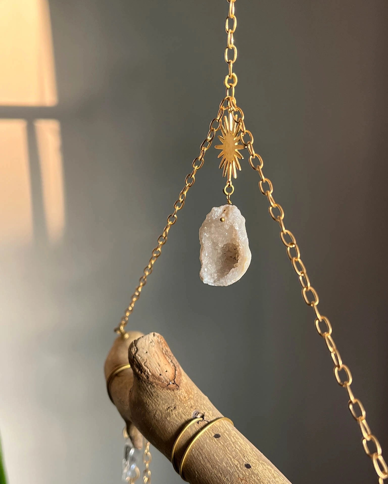 upcycled sun catcher with glass crystals, a wooden log base and a geode handmade by A Creator's Studio