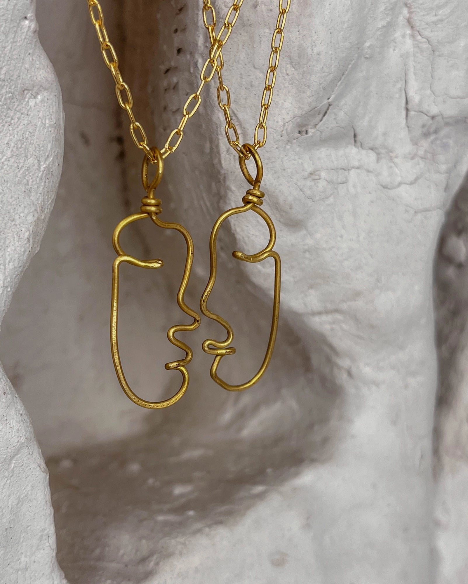 a set of two Brass wired face necklaces with chain handmade by A Creator's Studio