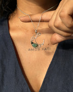 Sterling Silver Necklace with a wire wrapped moon pendant and an emerald gemstone handmade by A Creator's Studio