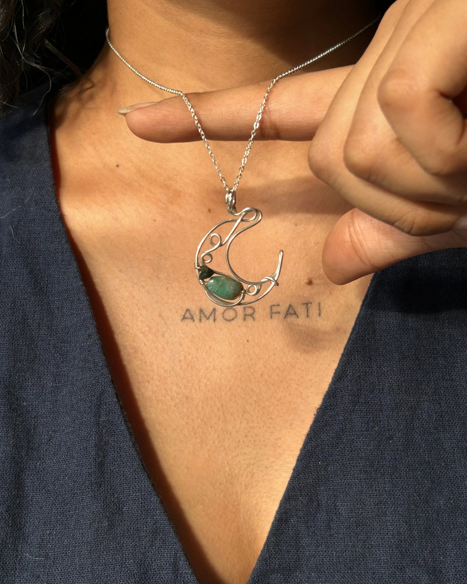 Sterling Silver Necklace with a wire wrapped moon pendant and an emerald gemstone handmade by A Creator's Studio