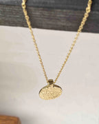 Brass necklace with a hammer texture coin pendant handmade by A Creator's Studio