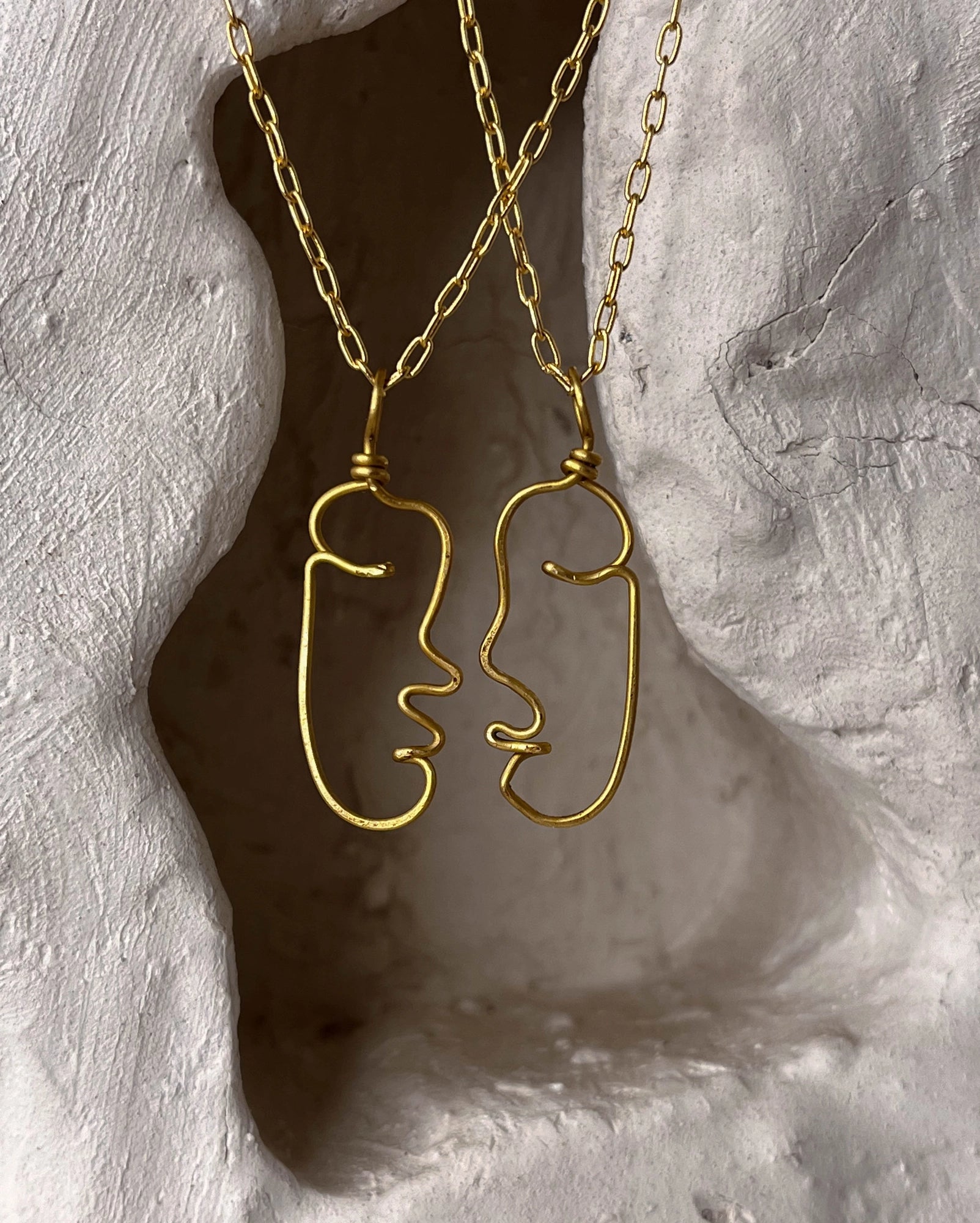 a set of two Brass wired face necklaces with chain handmade by A Creator's Studio