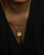 Brass necklace with a hammer texture coin pendant handmade by A Creator's Studio