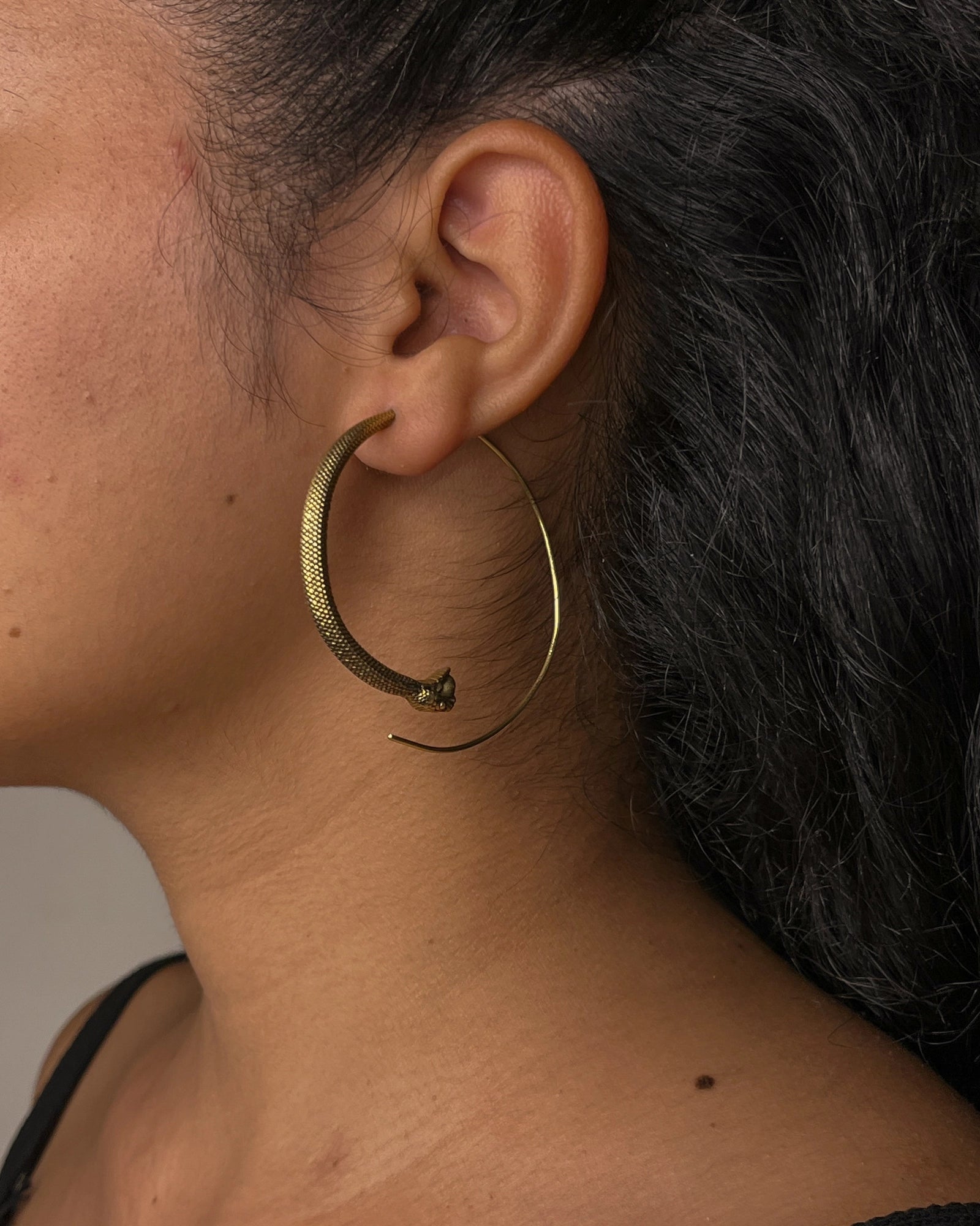 Brass snake hoop earrings handmade by A Creator's Studio