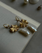 Gold plated dangle earrings with a flower charm and a freshwater pearl drop handmade by A Creator's Studio