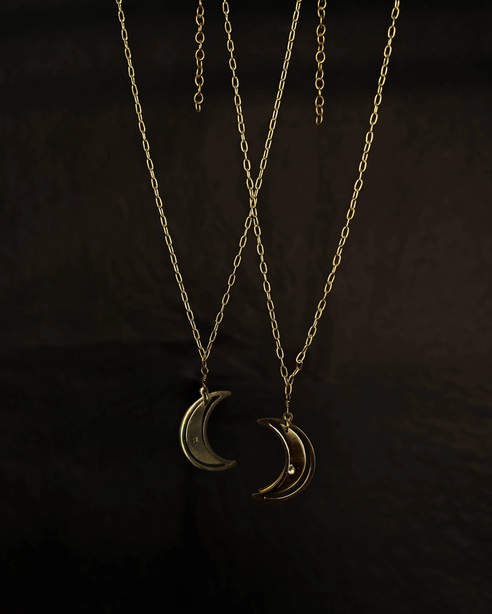 Brass necklace with a swinging and engraved crescent moon pendant handmade by A Creator's Studio