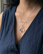 Sterling Silver Necklace with a wire wrapped moon pendant and an emerald gemstone handmade by A Creator's Studio