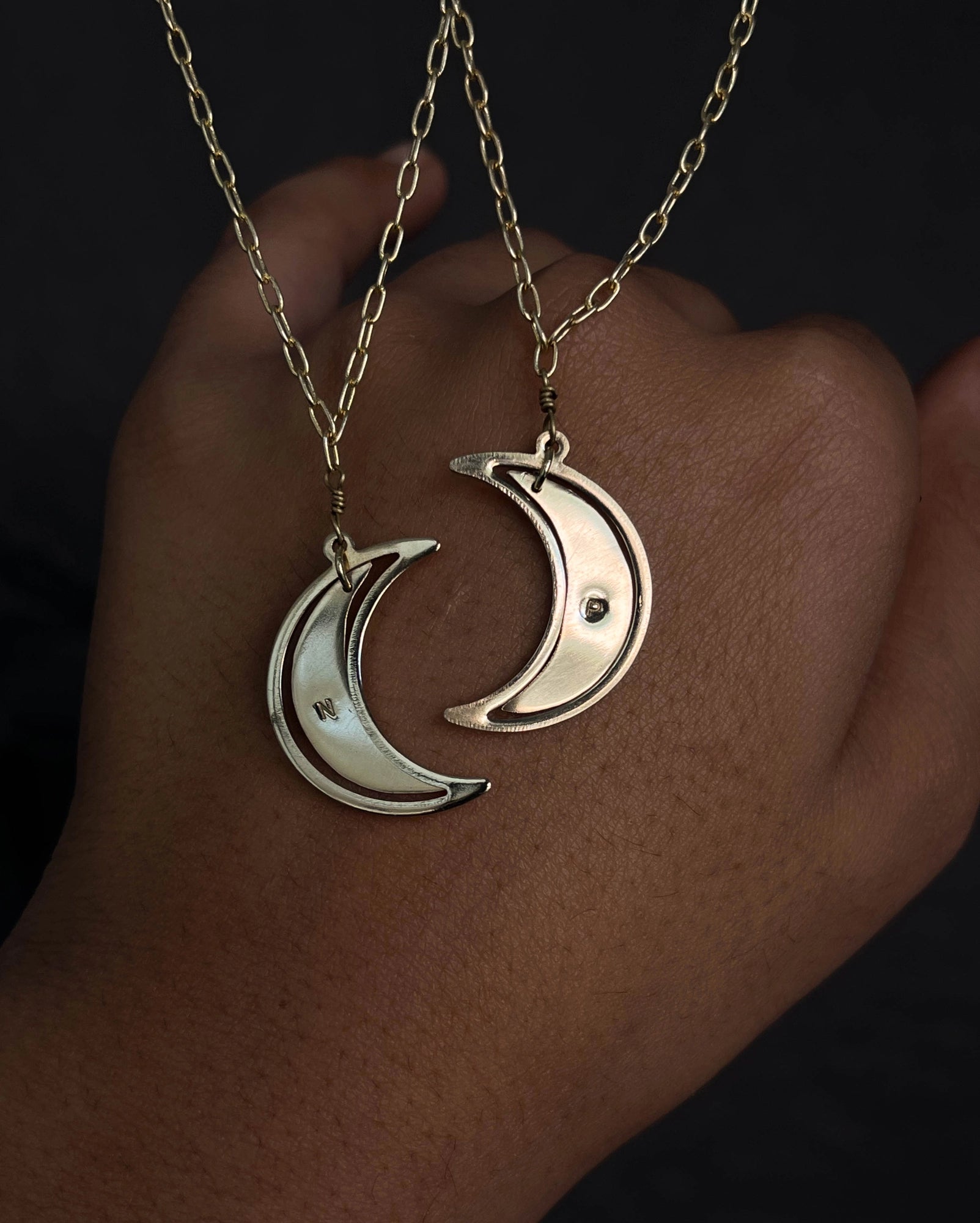 Brass necklace with a swinging and engraved crescent moon pendant handmade by A Creator's Studio