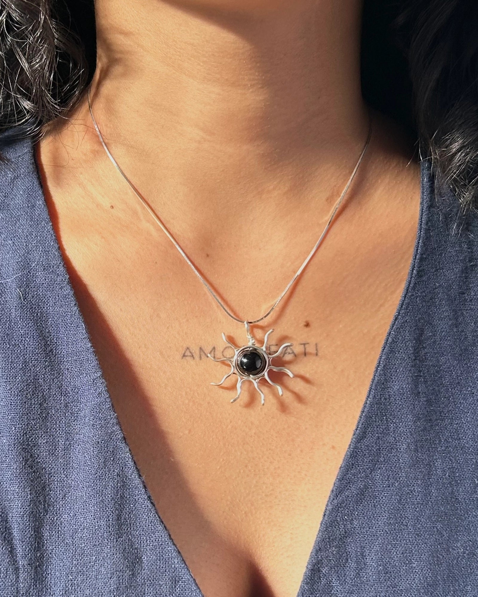 Sterling Silver Necklace with a wire wrapped sun pendant with a black onyx gemstone handmade by A Creator's Studio
