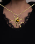 Brass wired sun necklace with a crystal in the centre handmade by A Creator's Studio