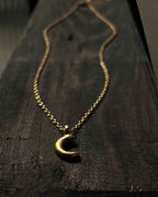 Brass necklace with a crescent moon pendant handmade by A Creator's Studio