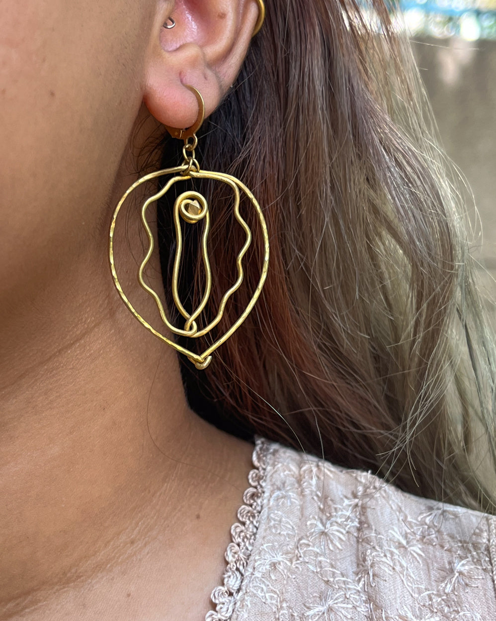 Brass earrings with unique vulva design handmade by A Creator's Studio
